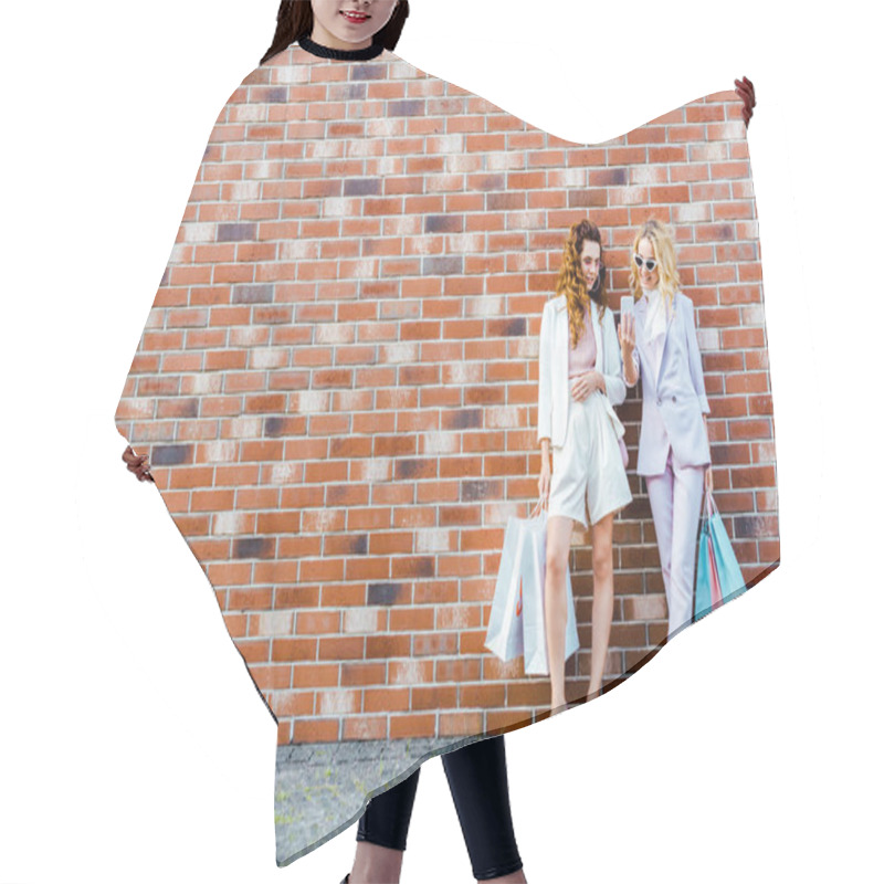 Personality  Beautiful Young Women With Shopping Bags Using Smartphone While Standing In Front Of Brick Wall Hair Cutting Cape