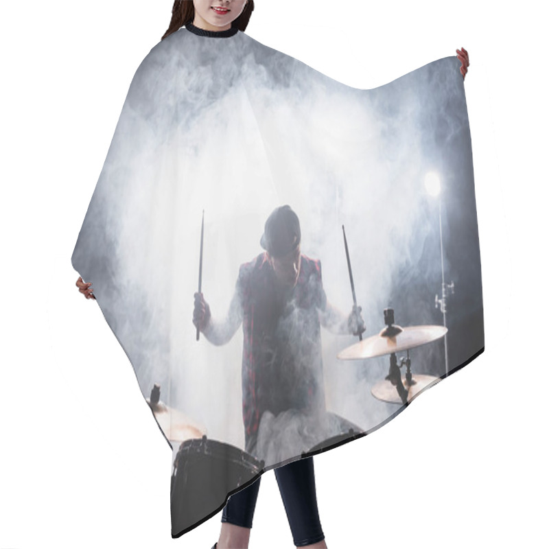 Personality  Musician With Drumsticks Playing While Sitting At Drum Kit With Smoke And Backlit On Background Hair Cutting Cape