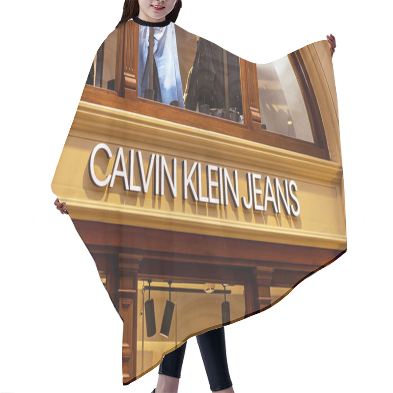 Personality  MOSCOW, RUSSIA - AUGUST 10, 2021: Calvin Klein Jeans Brand Retail Shop Logo Singboard On The Storefront In The Shopping Mall. Hair Cutting Cape