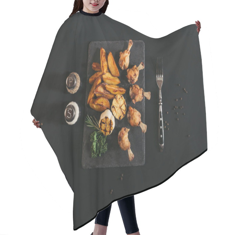 Personality  Top View Of Delicious Roasted Potatoes With Chicken And Grilled Garlic On Slate Board On Black  Hair Cutting Cape