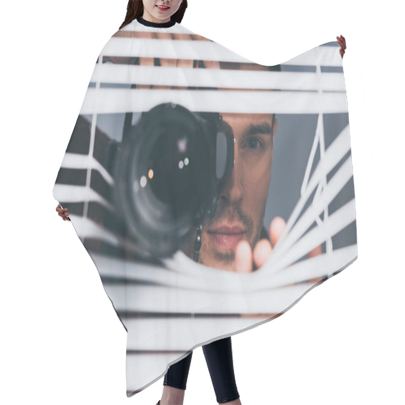 Personality  Young Man Holding Camera And Looking At Camera Through Blinds, Mistrust Concept Hair Cutting Cape