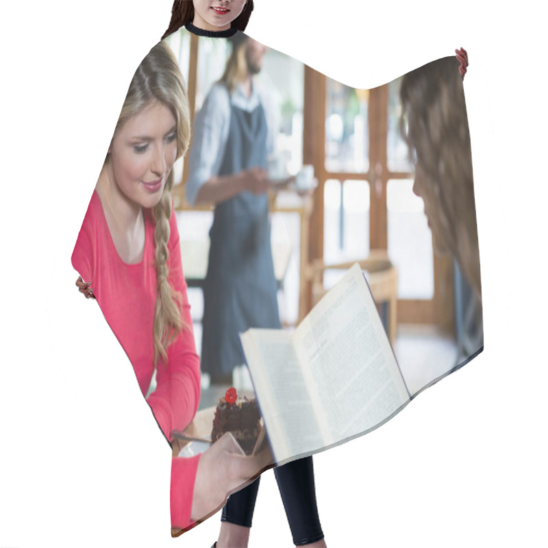 Personality  Woman Using Phone While Friend Reading Book  Hair Cutting Cape