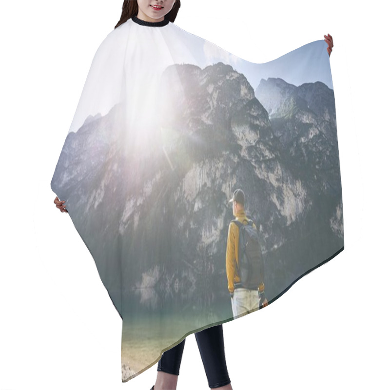 Personality  Young Photographer Holding Camera Against Lake Braies And Mountains During Sunrise. Dolomites, Italy  Hair Cutting Cape