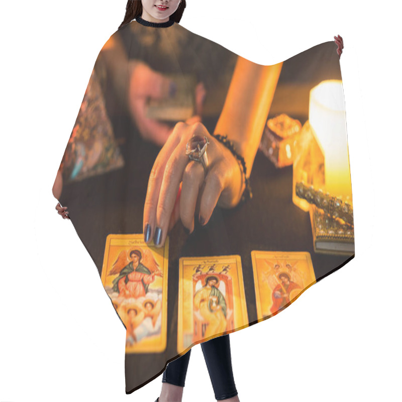 Personality  Detail Of A Woman's Hands Placing Tarot Cards On A Black Card Table During A Fortune Telling Session. Concept Of A Divination Session With Tarot Cards. Hair Cutting Cape