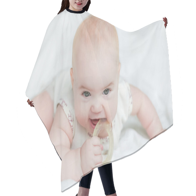 Personality  Baby Girl On Her Stomach With Teether In The Mouth Hair Cutting Cape