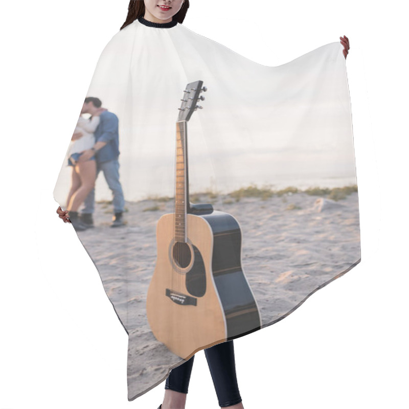 Personality  Selective Focus Of Acoustic Guitar On Sand And Young Couple Kissing On Beach At Sunset  Hair Cutting Cape