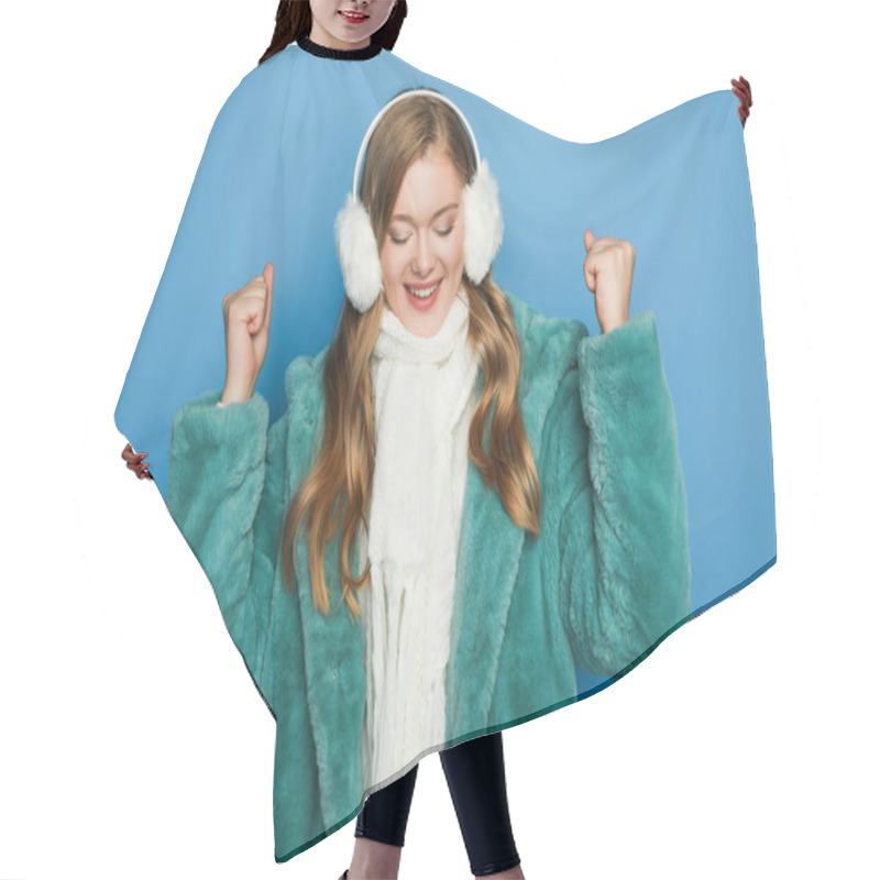 Personality  Happy Stylish Woman In Green Faux Fur Coat And Ear Muffs Isolated On Blue Hair Cutting Cape