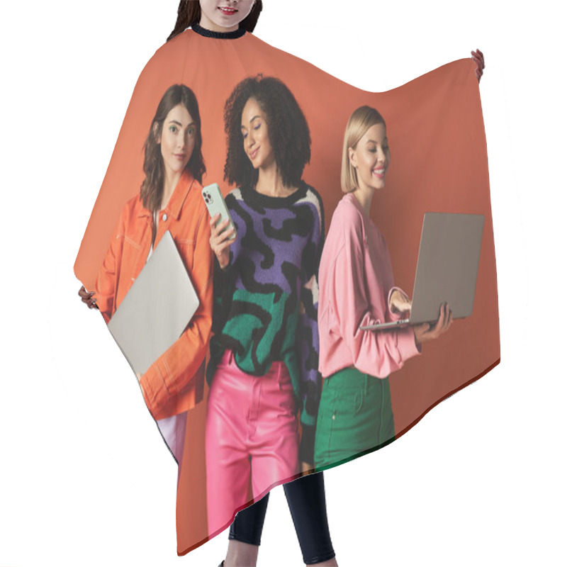 Personality  Three Young, Diverse Women Stand Together Holding Devices, Showcasing Modern Technology And Cultural Diversity. Hair Cutting Cape