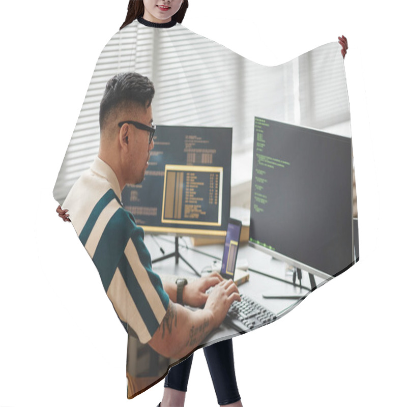 Personality  Side View Of Asian IT Developer Typing On Keyboard With Programming Code On Computer Screen While Working In Office Hair Cutting Cape