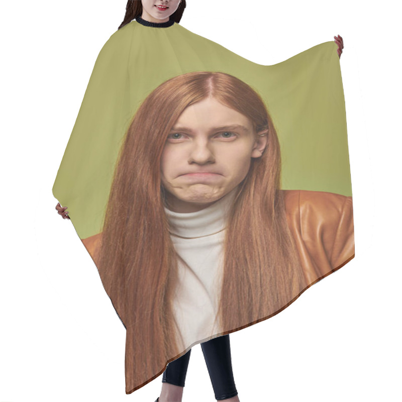 Personality  A Young Man With Long Red Hair Shows Deep Emotions Against A Bright Green Background. Hair Cutting Cape