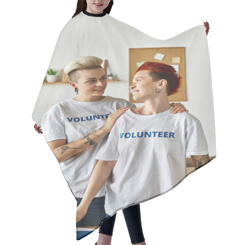 Personality  Young Lesbian Couple In Volunteer T-shirts, Standing United In A Room While Doing Charity Work Together. Hair Cutting Cape