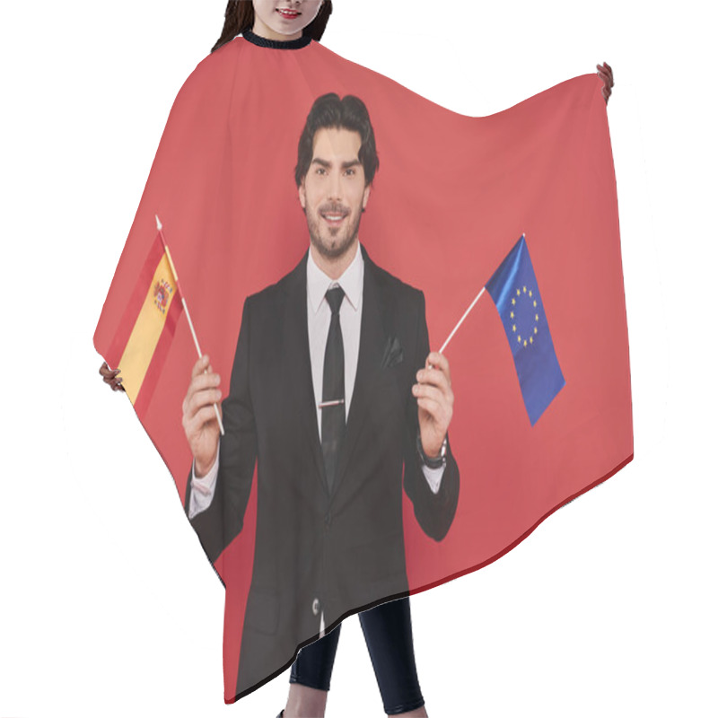 Personality  A Confident Young Man In A Sleek Suit Proudly Holds The Spanish And EU Flags. Hair Cutting Cape