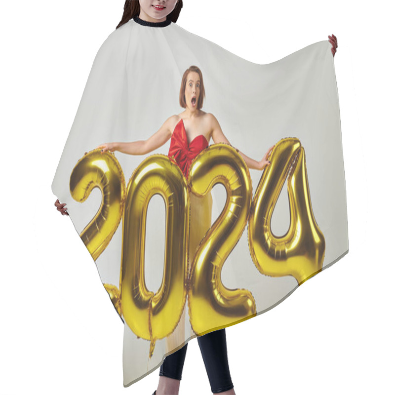 Personality  Happy New Year, Shocked Young Woman In Trendy Attire Holding Balloons With 2024 Numbers On Grey Hair Cutting Cape