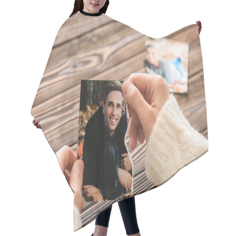 Personality  Woman Holding Torn Part Of Photo With Her Ex-husband. Concept Of Divorce Hair Cutting Cape