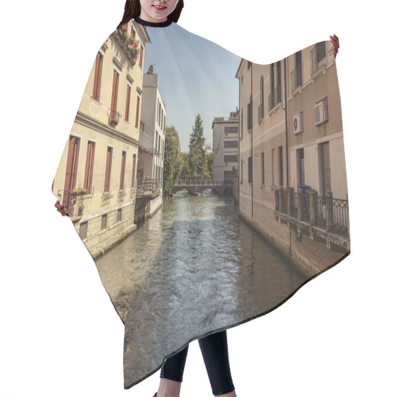 Personality  Treviso, Italy 1 January 2025: Water Flowing In Cagnan Grande Canal Between Residential Buildings With Bridge In The Background In Treviso, Italy Hair Cutting Cape