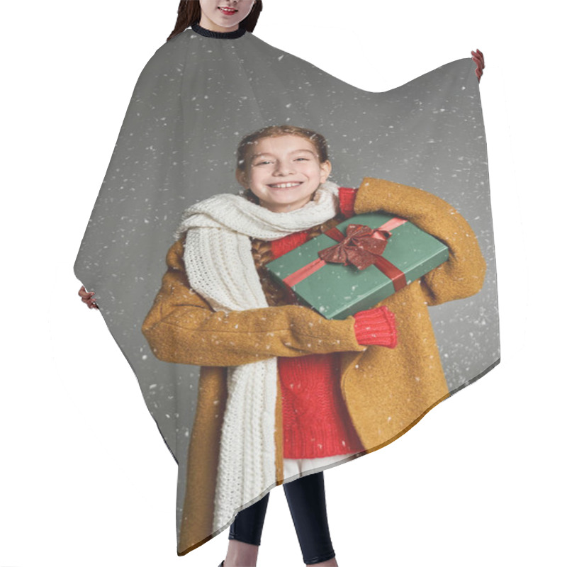 Personality  A Delighted Young Girl Dressed In Warm Winter Clothes Holds A Gift While Snowflakes Fall Around Her. Hair Cutting Cape