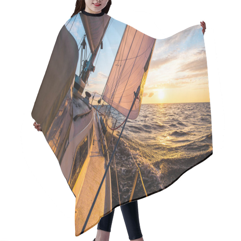 Personality  White Yacht Sailing At Sunset. A View From The Deck To The Bow And Sails. Waves And Clouds. Baltic Sea Hair Cutting Cape