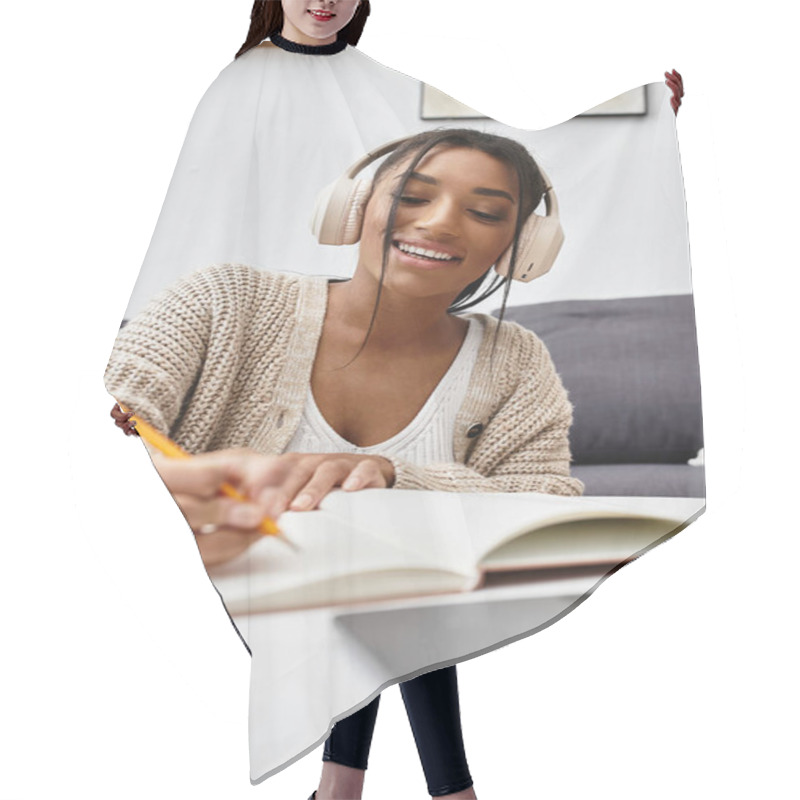 Personality  A Cheerful Young Woman Is Deeply Engaged In Her Studies At Home, Taking Notes With A Pencil. Hair Cutting Cape