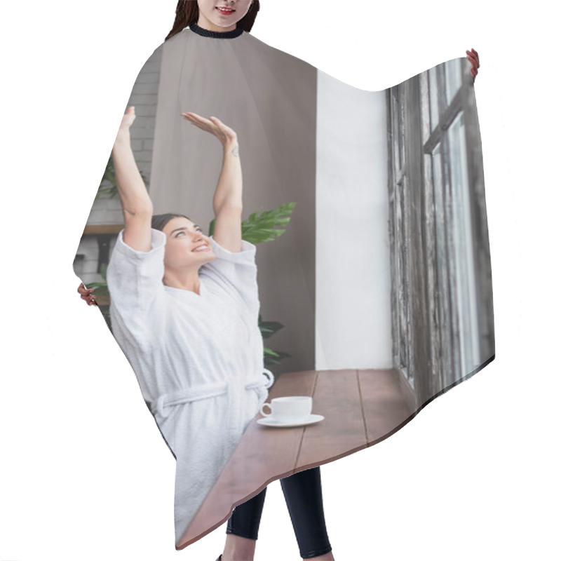 Personality  Happy Young Adult Woman In Bathrobe Standing Near Window With Hands In Air In Modern Living Room Hair Cutting Cape