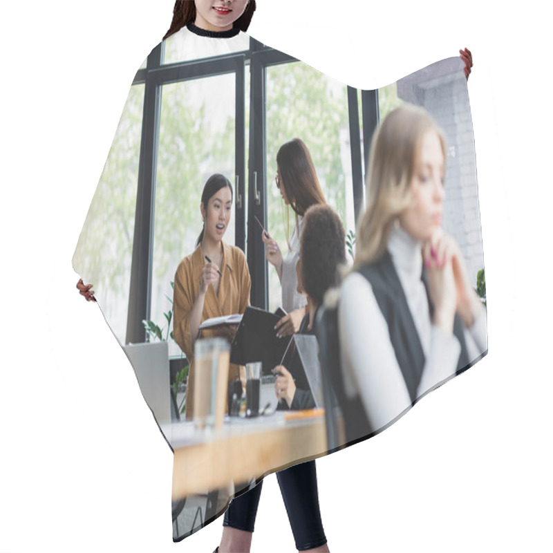 Personality  Excited Asian Woman Talking To Business Partner Near Blurred Multiethnic Colleagues Hair Cutting Cape