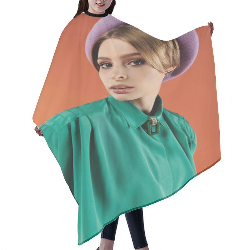 Personality  A Young Woman In A Vibrant Green Shirt And A Purple Beret Poses Against A Warm Orange Backdrop. Hair Cutting Cape