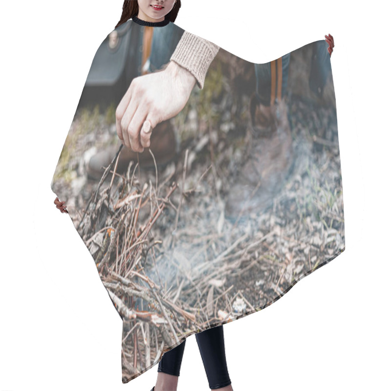 Personality  A Stock Photo Of A Man In Nature Sitting By A Small Fire, Warming Himself. Hair Cutting Cape