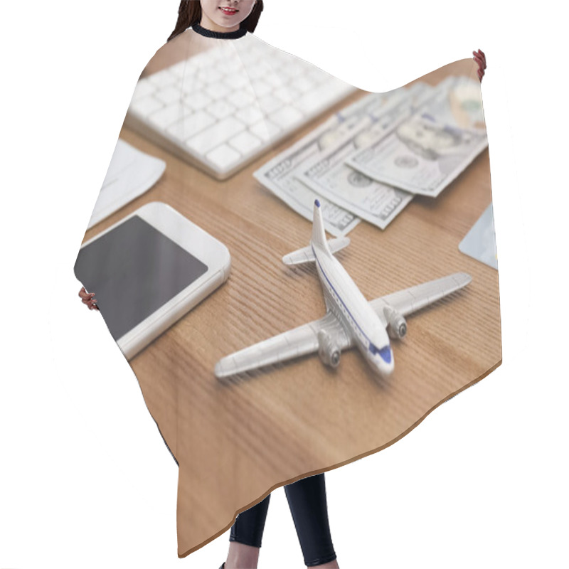 Personality  Composition With Airplane Model And Phone On Wooden Table In Travel Agency Hair Cutting Cape