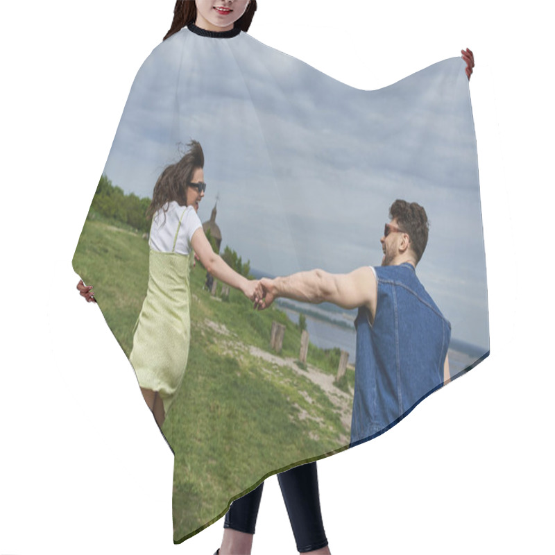 Personality  Side View Of Positive Romantic Couple In Sunglasses And Summer Outfits Holding Hands While Running On Grassy Hill With Blurred Landscape At Background, Countryside Wanderlust And Love Concept Hair Cutting Cape