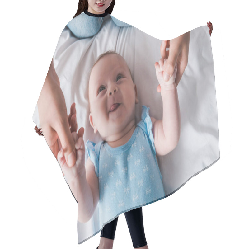 Personality  Cropped View Of Mother Holding Hands Of Adorable Infant Sticking Out Tongue  Hair Cutting Cape