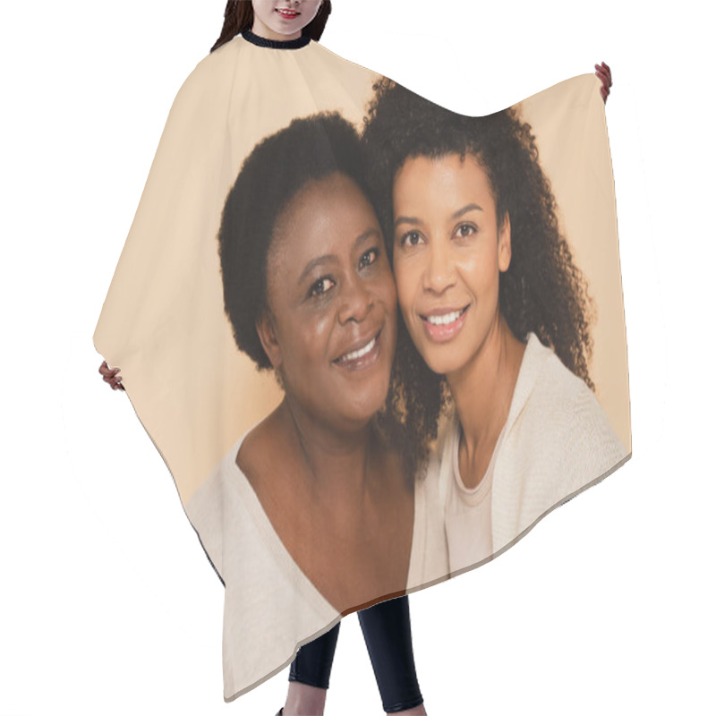 Personality  Smiling African American Adult Daughter And Middle Aged Mother Hugging Cheek To Cheek Isolated On Beige Hair Cutting Cape