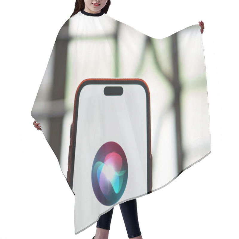 Personality  01 Jun 2024: Apple Siri Logo Is Displayed On Smartphone. Hair Cutting Cape