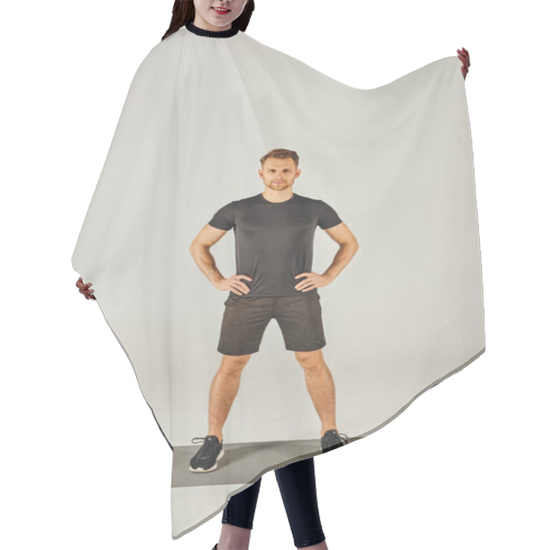 Personality  A Young Sportsman In Active Wear Stands On A Mat In Front Of A White Background, Showcasing Balance And Focus In A Studio. Hair Cutting Cape