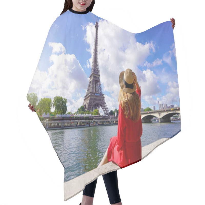 Personality  Young Traveler Woman In Red Dress And Hat Sitting On The Quay Of Seine River Looking At Eiffel Tower, Famous Landmark And Travel Destination In Paris. Hair Cutting Cape