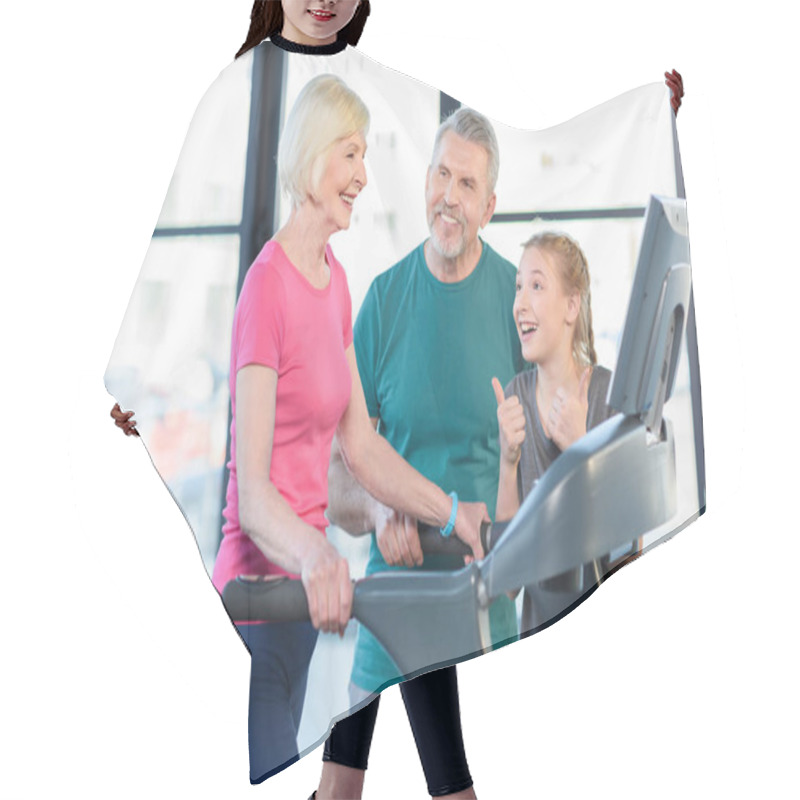 Personality  Senior Couple And Girl On Treadmill  Hair Cutting Cape