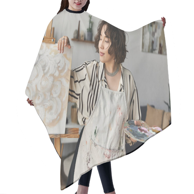 Personality  Young Woman With Curly Hair Joyfully Painting On An Easel In Her Bright Apartment. Hair Cutting Cape