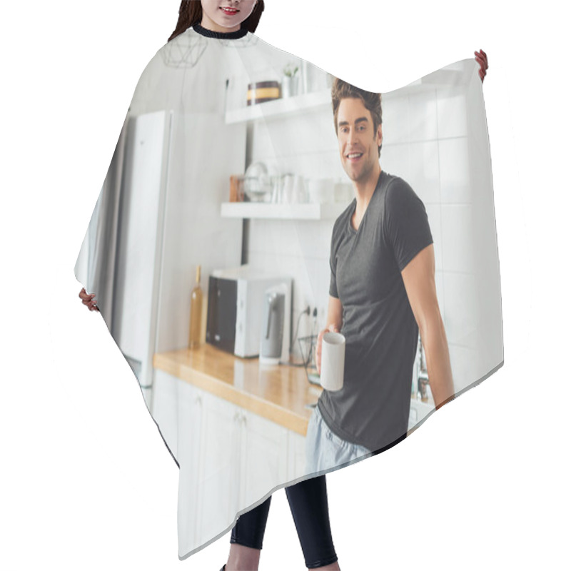 Personality  Selective Focus Of Handsome Man Smiling At Camera While Holding Cup Of Coffee Near Worktop In Kitchen  Hair Cutting Cape