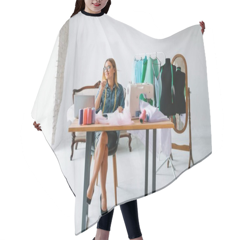 Personality  Smiling Fashion Designer Looking At Camera At Workplace, Dressmaker, Needlewoman Or Tailor Shop Owner Sitting At Desk With Color Swatches Pantone And Embroidery Design Sketches On The Wall, Portrait Hair Cutting Cape