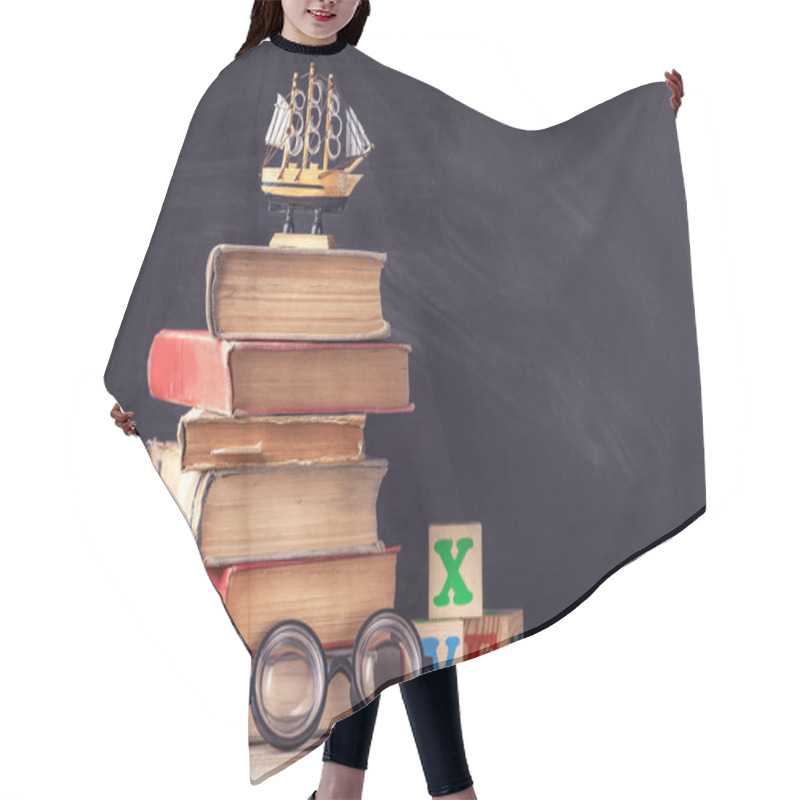 Personality  Old Textbooks Are On The Rustic Wooden Table On A Background Of Black Chalk Board. Hair Cutting Cape