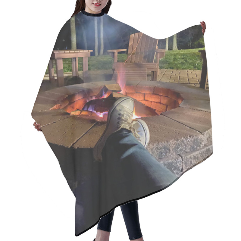 Personality  A Serene Nighttime Scene Featuring Feet Propped Up In Front Of A Warm, Inviting Fire Pit, Surrounded By Wooden Patio Chairs And Trees. Hair Cutting Cape