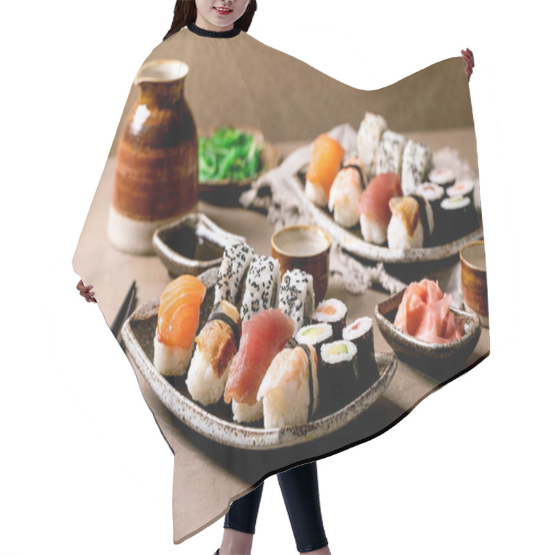 Personality  Sushi Rolls Set For Two. Traditional Japanese Dish Sushi And Rolls With Fresh Salmon, Tuna, Eel And Prawns On Rice. Serving On Plates With Soy Sauce And Sake On Brown Table. Japanese Style Dinner Hair Cutting Cape