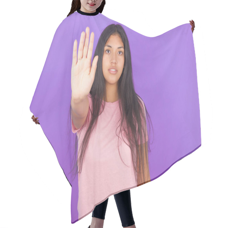 Personality  Hispanic Brunette Girl Wearing Pink T-shirt Over Purple Background Doing Stop Sing With Palm Of The Hand. Warning Expression With Negative And Serious Gesture On The Face. Hair Cutting Cape