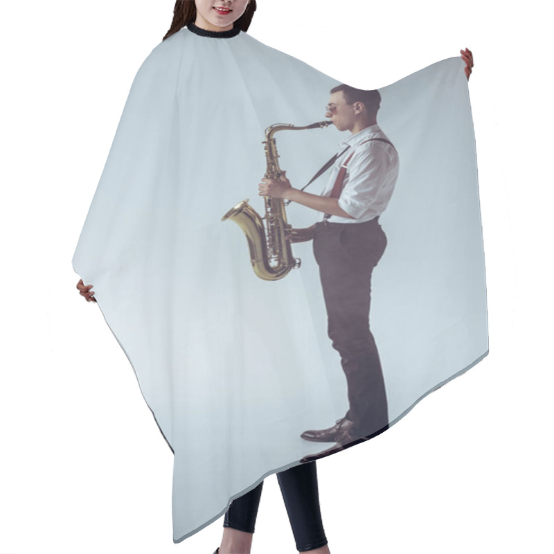 Personality  Side View Of Stylish Young Professional Musician Playing Saxophone On Grey Hair Cutting Cape