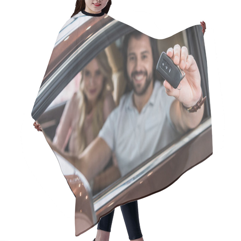 Personality  Selective Focus Of Smiling Couple With Car Key Sitting In New Car At Dealership Salon Hair Cutting Cape