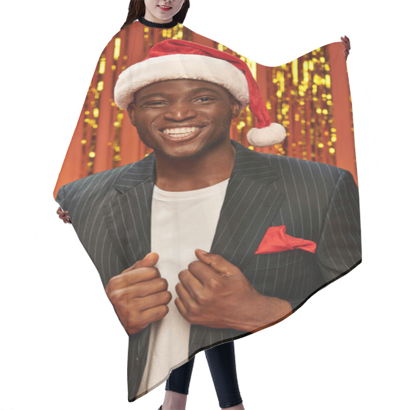 Personality  Happy African American Man In Santa Hat And Black Blazer Smiling On Shiny Background With Tinsel Hair Cutting Cape