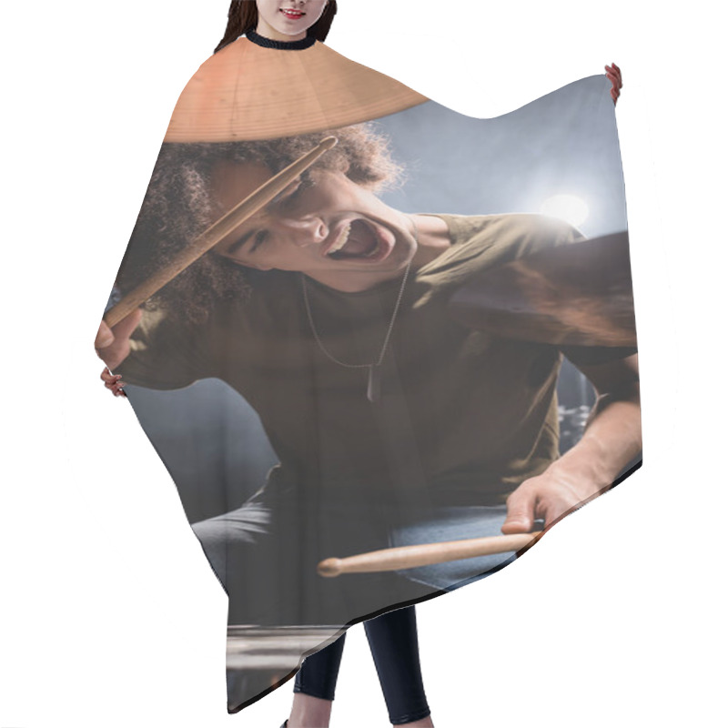 Personality  Curly Musician Shouting While Playing Drum With Drumsticks On Blurred Foreground Hair Cutting Cape