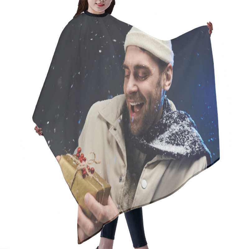 Personality  A Young Man Dressed Warmly Beams With Joy While Holding A Beautifully Wrapped Gift In The Snow. Hair Cutting Cape