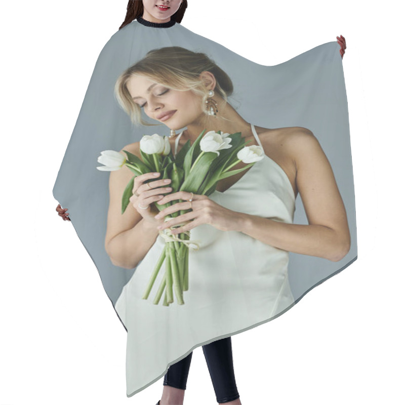 Personality  A Young Blonde Woman Exuding Elegance Holds A Bouquet Of Flowers In A White Dress Against A Grey Backdrop. Hair Cutting Cape