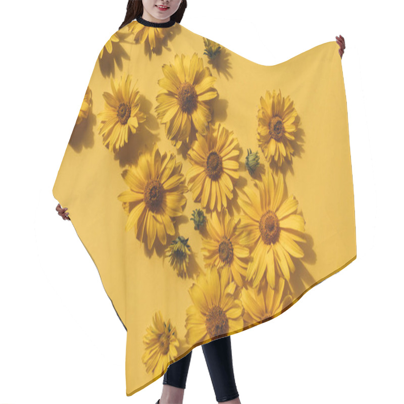 Personality  Flat Lay Yellow Daisy Flower Buds On Yellow Background. Top View. Hair Cutting Cape