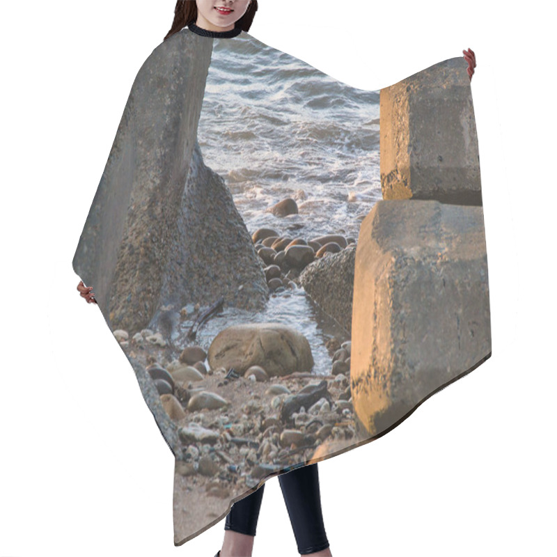 Personality  Massive Concrete Blocks Rest On A Rocky Shoreline, With Gentle Waves Crashing And Splashing In The Background Under Soft Light. Hair Cutting Cape