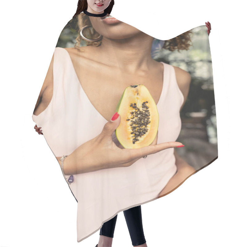 Personality  Cropped View Of Stylish Young African American Woman With Braces Wearing Summer Dress While Holding Cut Ripe Papaya In Blurred Garden Center, Fashion-forward Lady Inspired By Tropical Plants Hair Cutting Cape